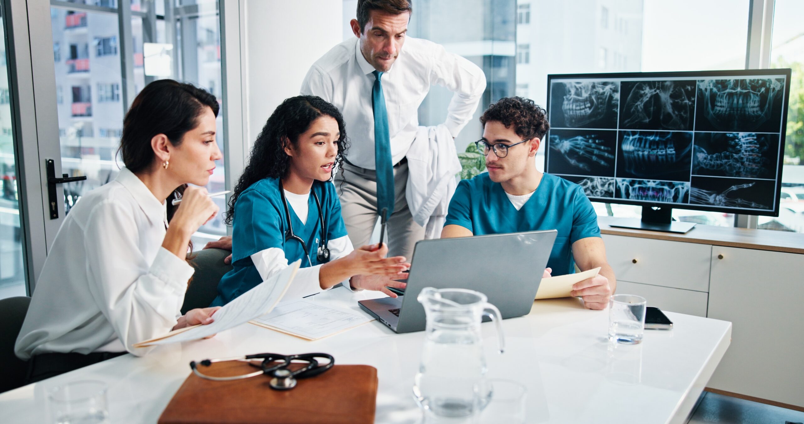 Doctor,,Team,And,Discussion,With,Laptop,Or,X,Ray,For